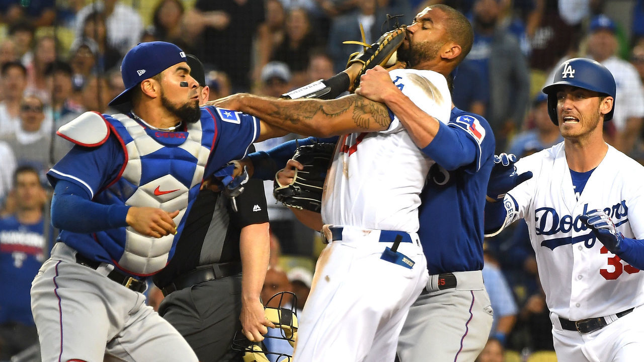 LOS ANGELES, CA - JUNE 13: Cole Hamels #35 of the Texas Rangers and Cody Bellinger #35 of the Los Angeles Dodgers try to hold back Matt Kemp #27 of the Los Angeles Dodgers and Robinson Chirinos #61 of the Texas Rangers as tempers flared after a collision at home plate in the third inning at Dodger Stadium on June 13, 2018 in Los Angeles, California. A benches clearing brawl erupted with Kemp being ejected from the game.