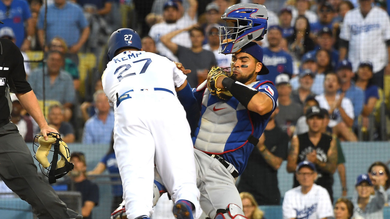 LOS ANGELES, CA - JUNE 13: Matt Kemp #27 of the Los Angeles Dodgers is out at the plate as he collides with Robinson Chirinos #61 of the Texas Rangers in the third inning at Dodger Stadium on June 13, 2018 in Los Angeles, California. A benches clearing brawl erupted with Kemp being ejected from the game.