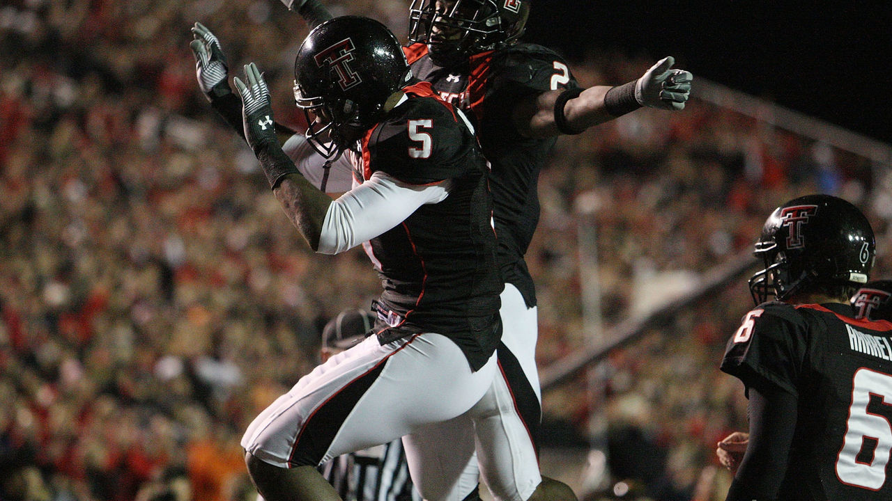 LUBBOCK, TX - NOVEMBER 08: Wide receiver Michael Crabtree #5 of the Texas Tech Red Raiders celebrates a touchdown with Shannon Woods #2 during play against the Oklahoma State Cowboys at Jones AT&T Stadium on November 8, 2008 in Lubbock, Texas.