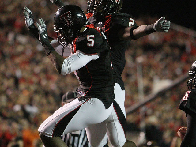 LUBBOCK, TX - NOVEMBER 08: Wide receiver Michael Crabtree #5 of the Texas Tech Red Raiders celebrates a touchdown with Shannon Woods #2 during play against the Oklahoma State Cowboys at Jones AT&T Stadium on November 8, 2008 in Lubbock, Texas.