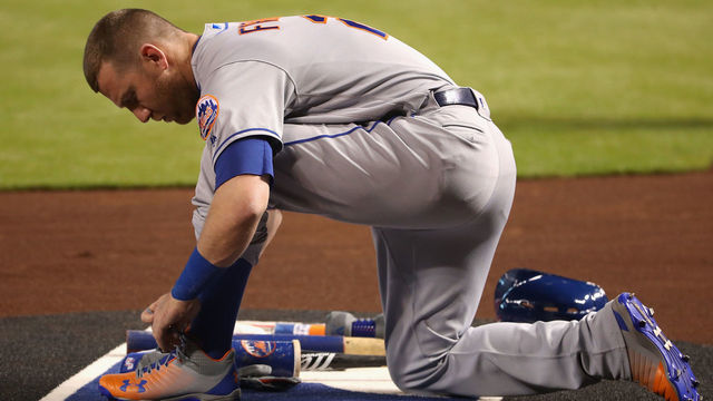 PHOENIX, AZ - JUNE 14: Todd Frazier #21 of the New York Mets ties his laces on-deck during the first inning of the MLB game against the Arizona Diamondbacks at Chase Field on June 14, 2018 in Phoenix, Arizona.