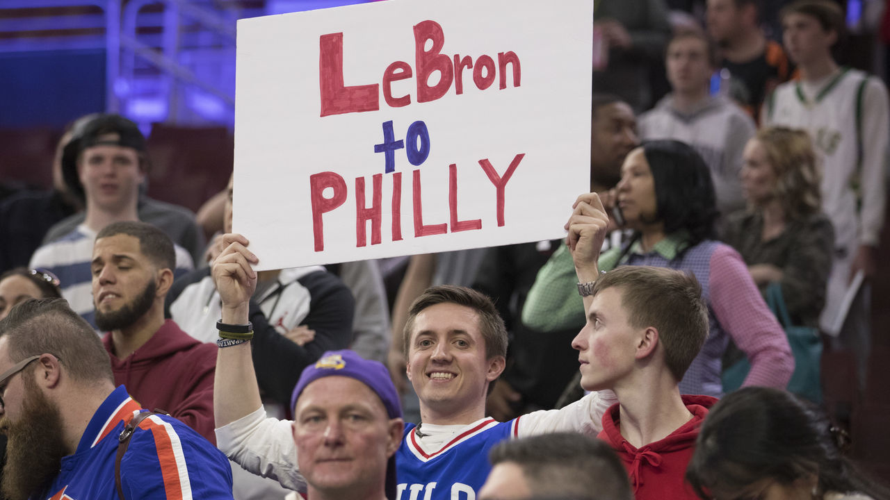 PHILADELPHIA, PA - APRIL 6: A Philadelphia 76ers fan holds up a sign asking LeBron James #23 of the Cleveland Cavaliers to come to Philadelphia prior to the game at the Wells Fargo Center on April 6, 2018 in Philadelphia, Pennsylvania.