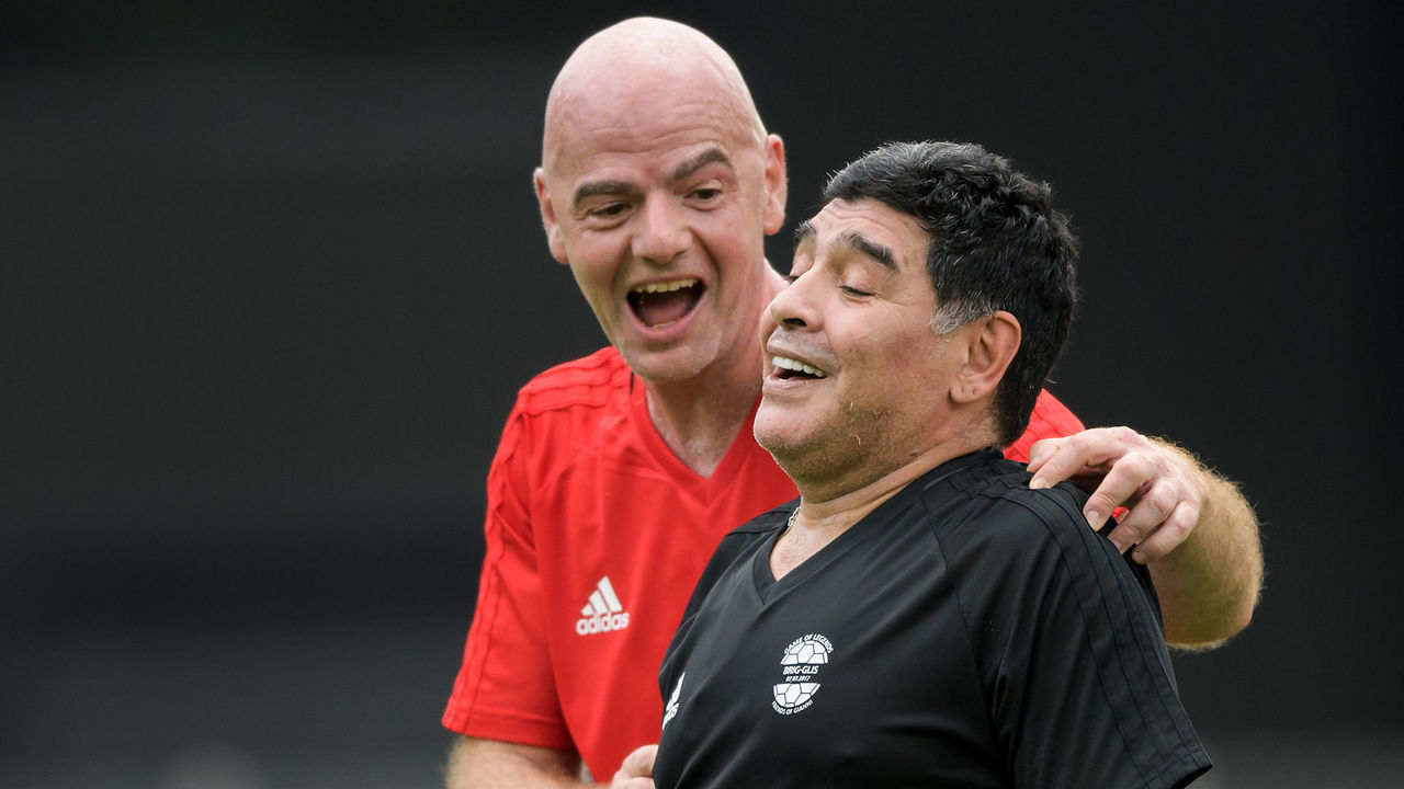 FIFA President Gianni Infantino (L) congratulates former Argentinian football star Diego Maradona after he scored a goal during 'The Gianni's game, the match of legends', a football match with football legends in honour of FIFA's President on July 7, 2017 in Brig. / AFP PHOTO / Fabrice COFFRINI