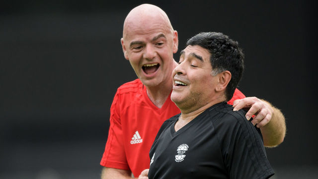 FIFA President Gianni Infantino (L) congratulates former Argentinian football star Diego Maradona after he scored a goal during 'The Gianni's game, the match of legends', a football match with football legends in honour of FIFA's President on July 7, 2017 in Brig. / AFP PHOTO / Fabrice COFFRINI