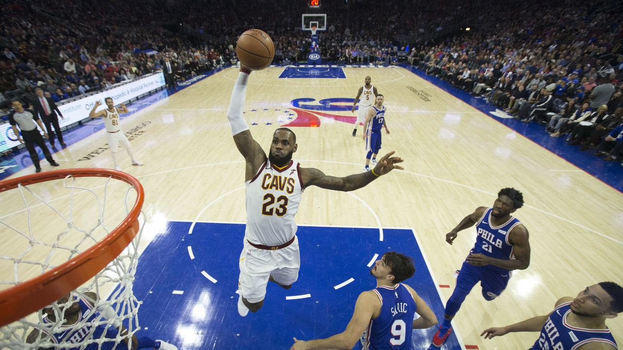 PHILADELPHIA, PA - NOVEMBER 27: LeBron James #23 of the Cleveland Cavaliers dunks the ball past Robert Covington #33, Dario Saric #9, Joel Embiid #21, and Ben Simmons #25 of the Philadelphia 76ers in the third quarter at the Wells Fargo Center on November 27, 2017 in Philadelphia, Pennsylvania. The Cavaliers defeated the 76ers 113-91.