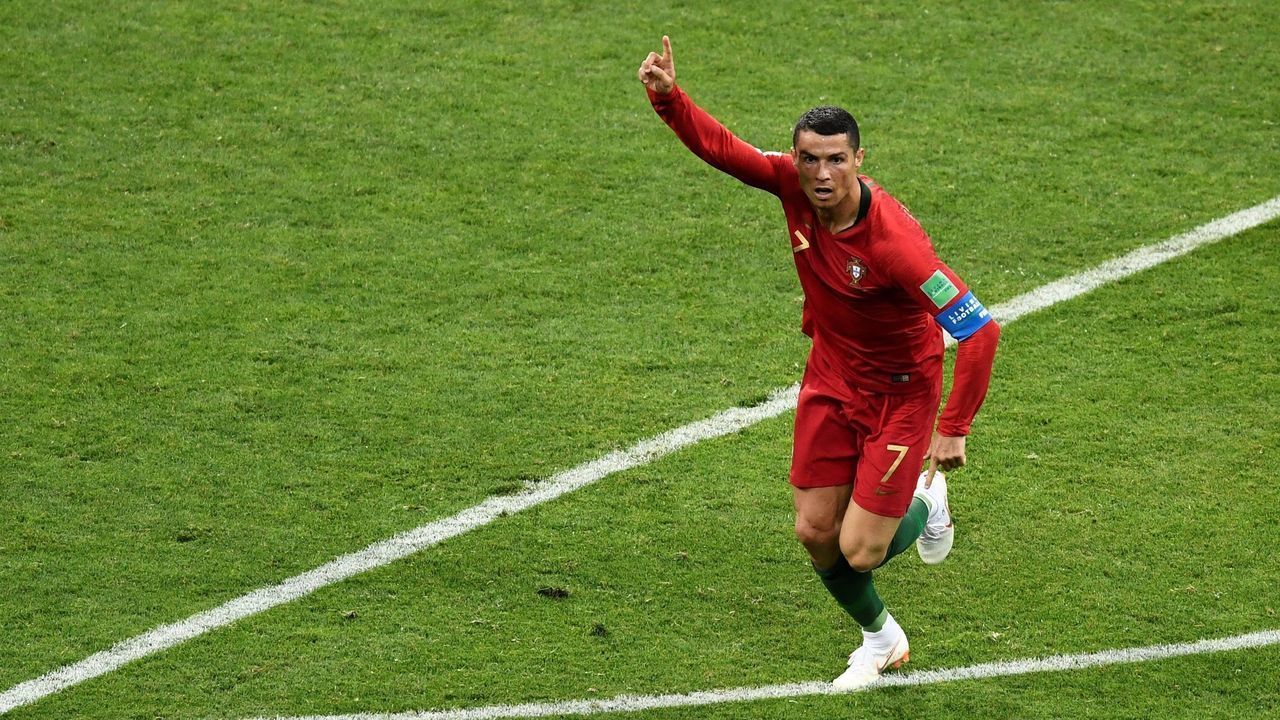 TOPSHOT - Portugal's forward Cristiano Ronaldo celebrates after scoring the second goal during the Russia 2018 World Cup Group B football match between Portugal and Spain at the Fisht Stadium in Sochi on June 15, 2018.