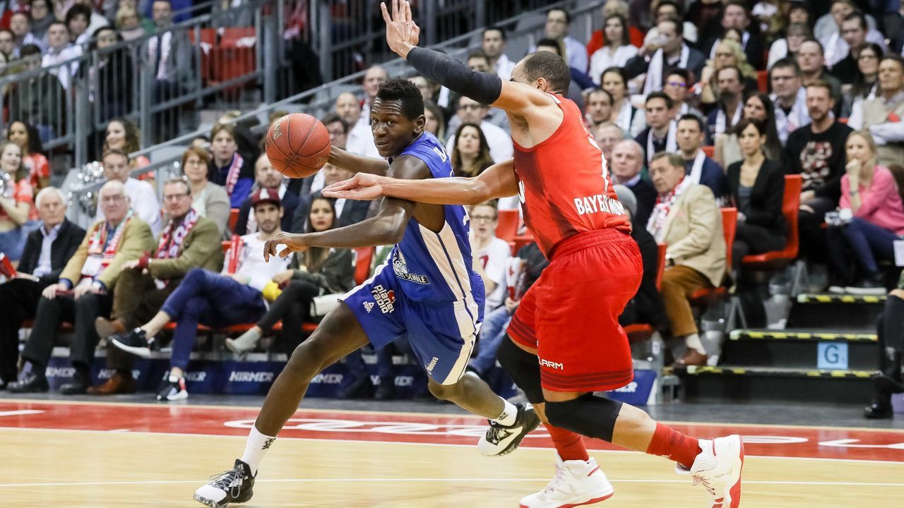 MUNICH, GERMANY - FEBRUARY 04: Isaac Bonga of Fraport Skyliners and Alex King of FC Bayern Muenchen battle for the ball during the game between FC Bayern Muenchen and the Fraport Skyliners at Audi Dome on February 4, 2017 in Munich, Germany.