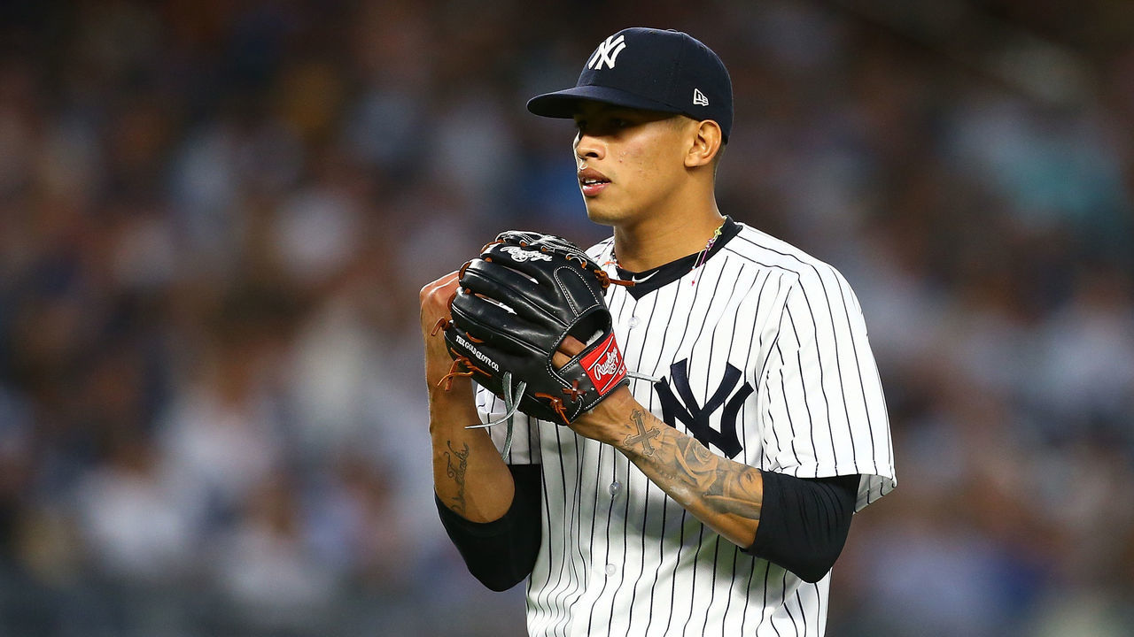 NEW YORK, NY - JUNE 15: Jonathan Loaisiga #38 of the New York Yankees pumps his fist into his glove after the third out of the top of the fifth inning against the Tampa Bay Rays at Yankee Stadium on June 15, 2018 in the Bronx borough of New York City.