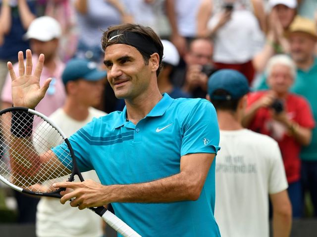 Switzerland's Roger Federer celebrates winning against Canada's Milos Raonic after the final match at the ATP Mercedes Cup tennis tournament in Stuttgart, southwestern Germany, on June 17, 2018. - Roger Federer claimed his 98th ATP title with a 6-4, 7-6 (7/3) defeat of Milos Raonic in the grass-court Stuttgart Cup final.