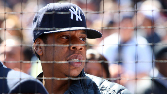 NEW YORK - APRIL 16: Recording artist Jay-Z looks on during the opening day game between the Cleveland Indians and the New York Yankees at the new Yankee Stadium on April 16, 2009 in the Bronx borough of New York City. This is the first regular season MLB game being played at the new venue which replaced the old Yankee Stadium as the Yankees home field.