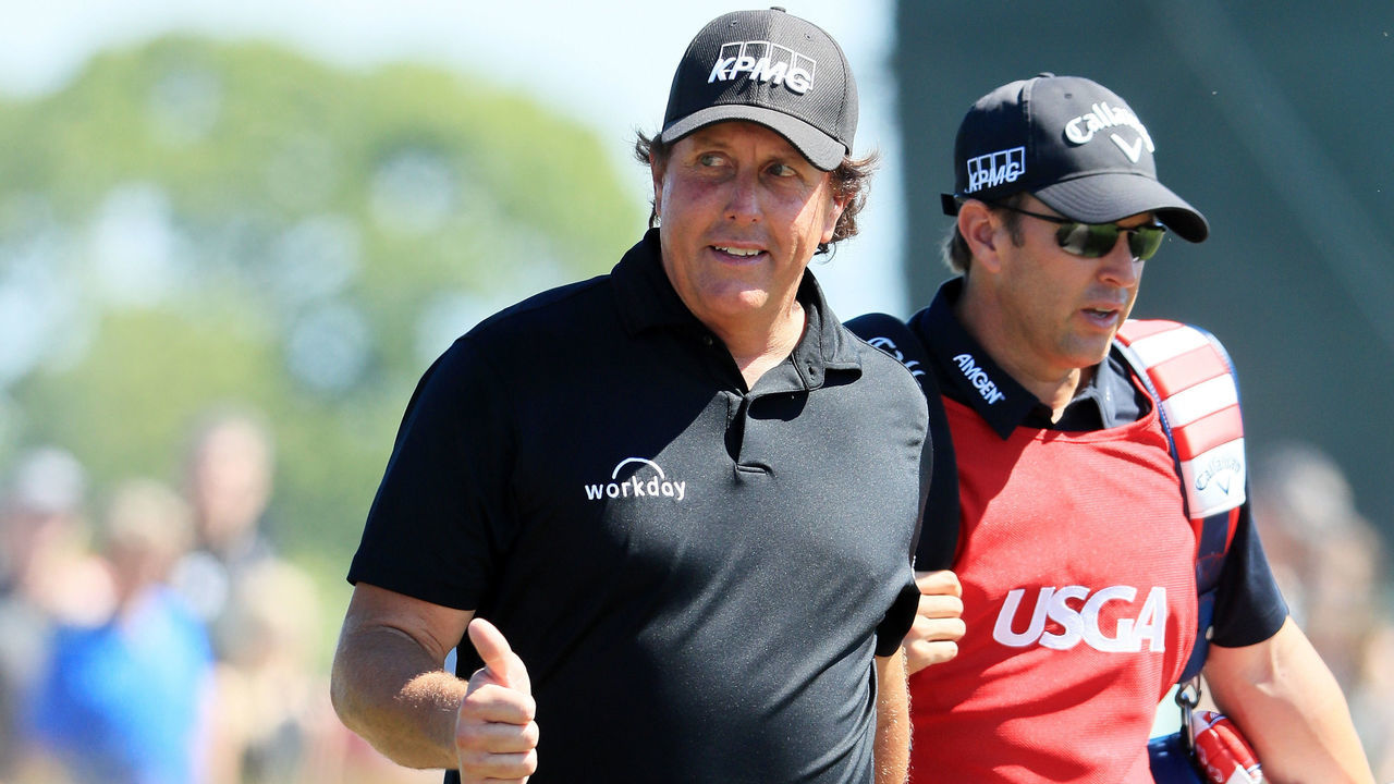 SOUTHAMPTON, NY - JUNE 17: Phil Mickelson of the United States and caddie Tim Mickelson walk on the seventh hole during the final round of the 2018 U.S. Open at Shinnecock Hills Golf Club on June 17, 2018 in Southampton, New York.