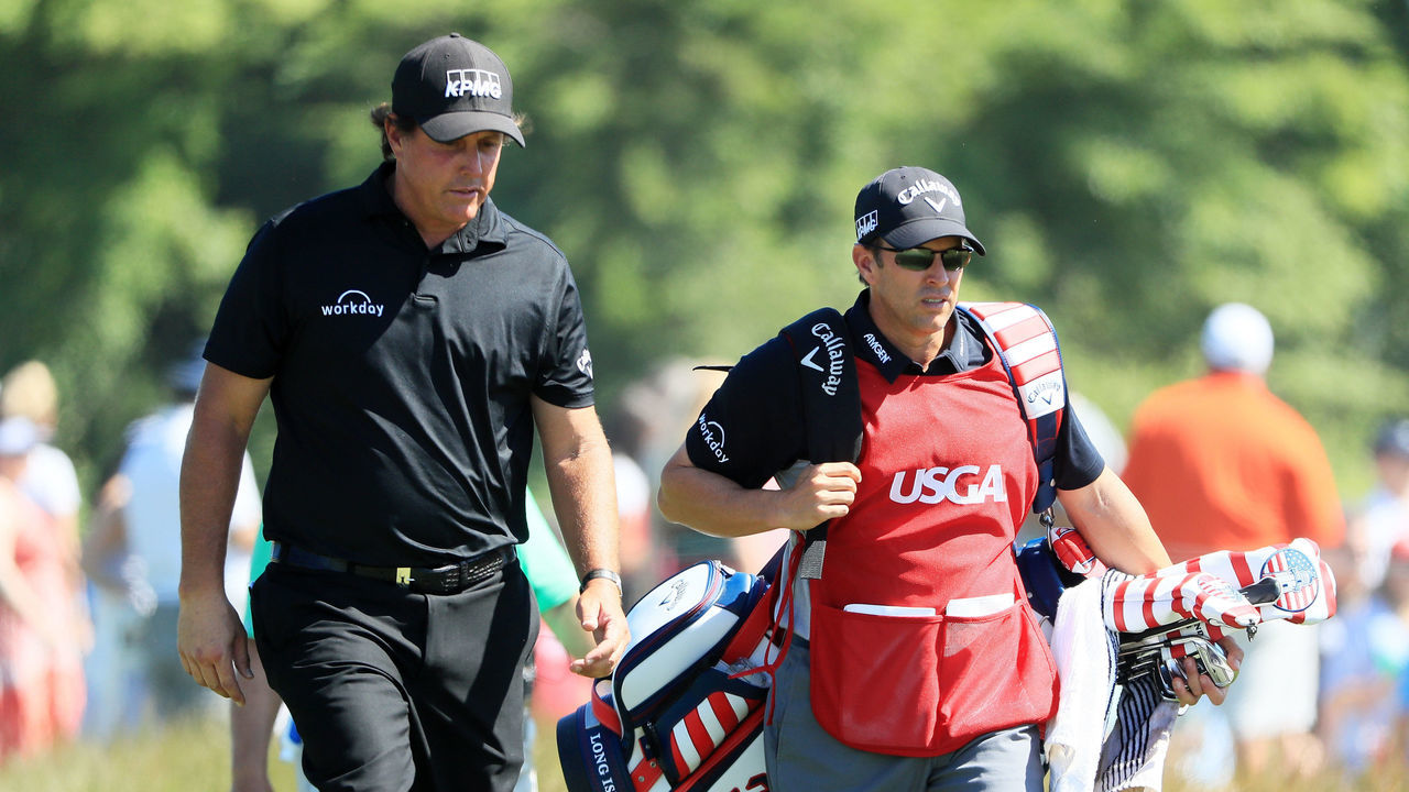 SOUTHAMPTON, NY - JUNE 17: Phil Mickelson of the United States and caddie Tim Mickelson walk on the seventh hole during the final round of the 2018 U.S. Open at Shinnecock Hills Golf Club on June 17, 2018 in Southampton, New York.