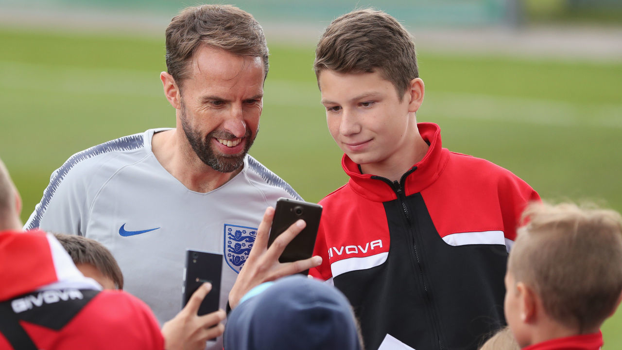 SAINT PETERSBURG, RUSSIA - JUNE 13: Gareth Southgate, Manager of England poses for a photo with fans during a training session as part of the England media access at Spartak Zelenogorsk Stadium ahead of the FIFA World Cup 2018 on June 13, 2018 in Saint Petersburg, Russia.