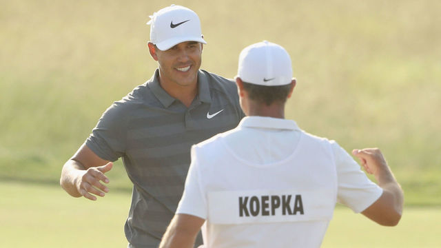 SOUTHAMPTON, NY - JUNE 17: Brooks Koepka of the United States celebrates with caddie Richard Elliott on the 18th green during the final round of the 2018 U.S. Open at Shinnecock Hills Golf Club on June 17, 2018 in Southampton, New York.
