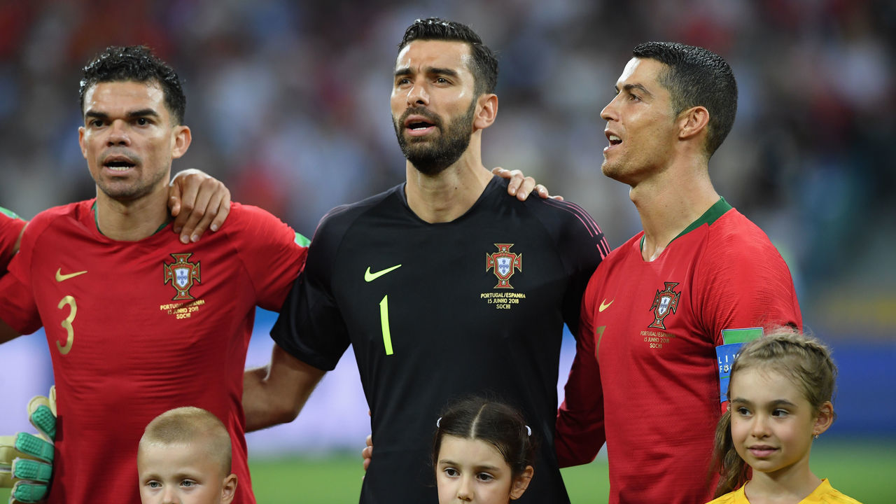 SOCHI, RUSSIA - JUNE 15: Portugal player Cristiano Ronaldo (r) looks on during the singing of the national anthem with Pepe (l) and Rui Patricio during the 2018 FIFA World Cup Russia group B match between Portugal and Spain at Fisht Stadium on June 15, 2018 in Sochi, Russia.