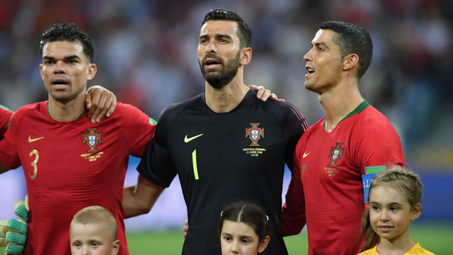 SOCHI, RUSSIA - JUNE 15: Portugal player Cristiano Ronaldo (r) looks on during the singing of the national anthem with Pepe (l) and Rui Patricio during the 2018 FIFA World Cup Russia group B match between Portugal and Spain at Fisht Stadium on June 15, 2018 in Sochi, Russia.