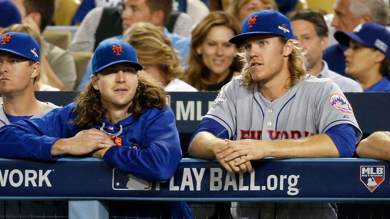 LOS ANGELES, CA - OCTOBER 15: Jacob deGrom #48 and Noah Syndergaard #34 of the New York Mets watch from the dugout in the eighth inning against the Los Angeles Dodgers in game five of the National League Division Series at Dodger Stadium on October 15, 2015 in Los Angeles, California.