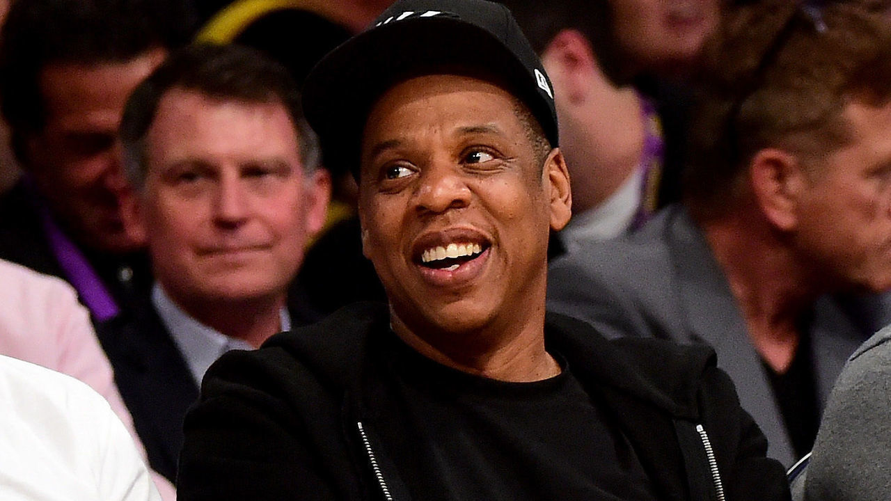 LOS ANGELES, CA - APRIL 13: Jay-Z smiles as he sits courtside as the Los Angeles Lakers take on the Utah Jazz at Staples Center on April 13, 2016 in Los Angeles, California.