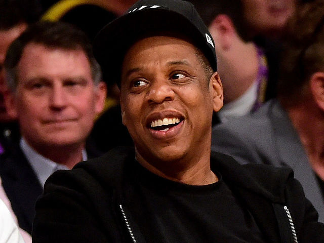 LOS ANGELES, CA - APRIL 13: Jay-Z smiles as he sits courtside as the Los Angeles Lakers take on the Utah Jazz at Staples Center on April 13, 2016 in Los Angeles, California.