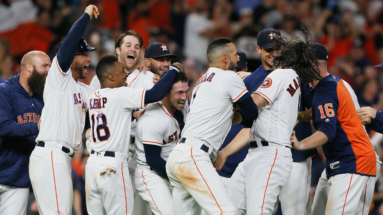 HOUSTON, TX - JUNE 18: Alex Bregman #2 of the Houston Astros is mobbed by his teammates after hitting a walkoff double in the ninth inning against the Tampa Bay Rays for a 5-4 win at Minute Maid Park on June 18, 2018 in Houston, Texas.