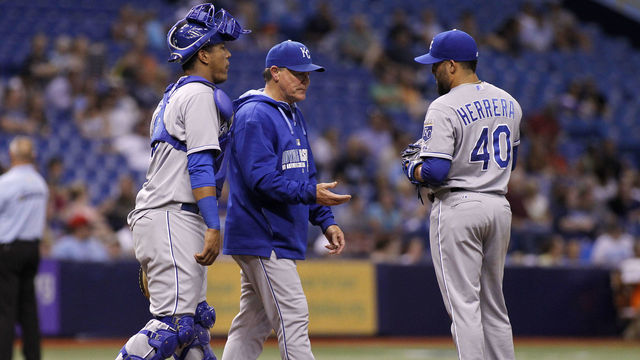 ST. PETERSBURG, FL - JULY 9: Manager Ned Yost #3 walkes out with catcher Salvador Perez #13 to take pitcher Kelvin Herrera #40 of the Kansas City Royals off the mound during the sixth inning of a game against the Tampa Bay Rays on July 9, 2014 at Tropicana Field in St. Petersburg, Florida.