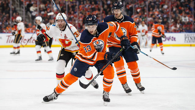EDMONTON, AB - JANUARY 25: Matthew Benning #83 of the Edmonton Oilers is pursued by Troy Brouwer #36 of the Calgary Flames at Rogers Place on January 25, 2018 in Edmonton, Canada.