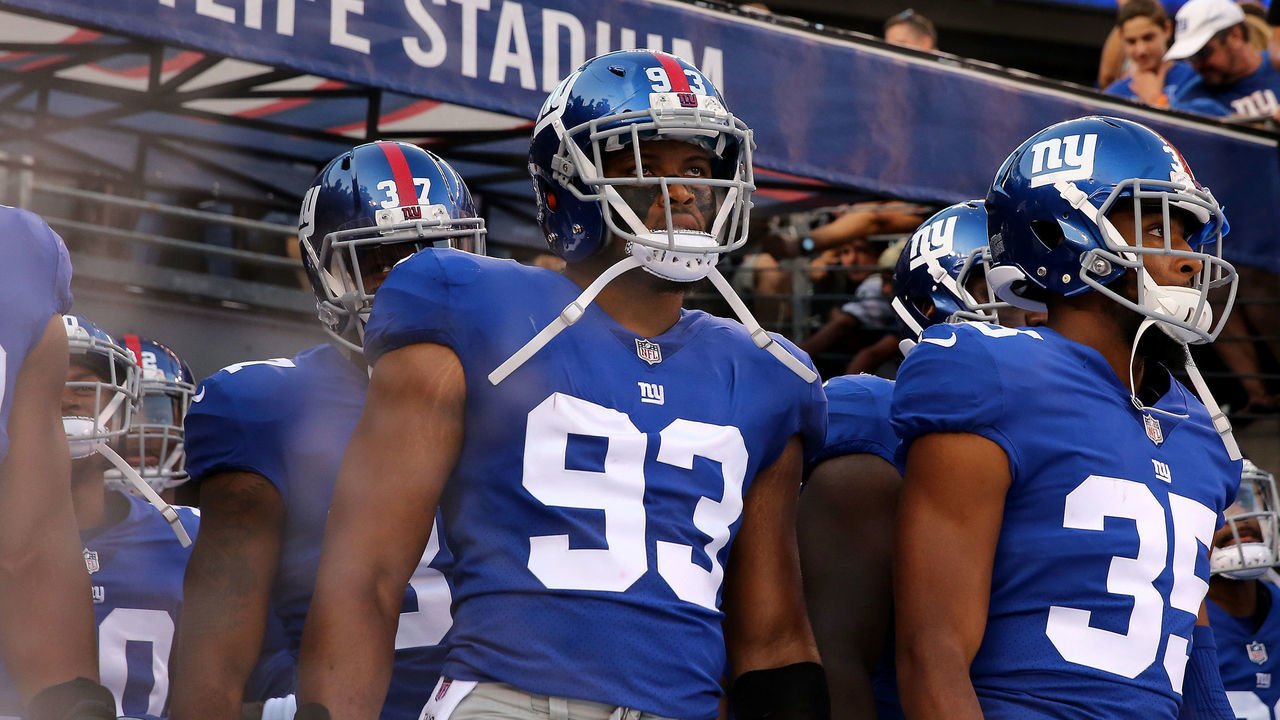 EAST RUTHERFORD, NJ - AUGUST 26: B.J. Goodson #93 and Nigel Tribune #35 of the New York Giants take the field before the game against the New York Jets during a preseason game on August 26, 2017 at MetLife Stadium in East Rutherford, New Jersey