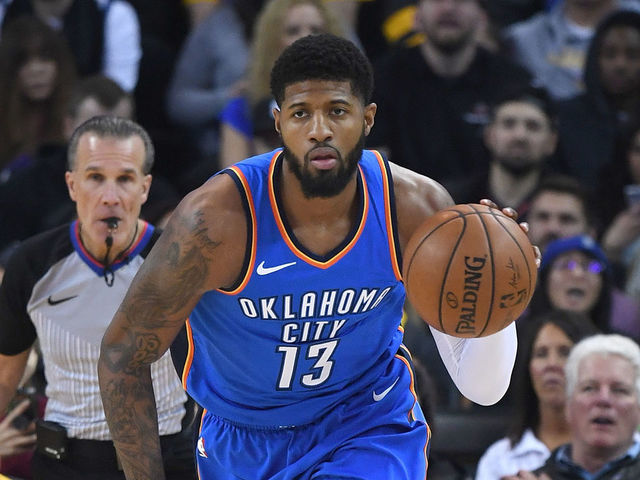 OAKLAND, CA - FEBRUARY 06: Paul George #13 of the Oklahoma City Thunder dribbles the ball up court against the Golden State Warriors during the first half of their NBA basketball game at ORACLE Arena on February 6, 2018 in Oakland, California.
