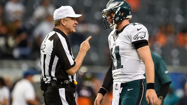 CHICAGO, IL - SEPTEMBER 19: Referee Jeff Triplette #42 talks with quarterback Carson Wentz #11 of the Philadelphia Eagles prior to the game against the Chicago Bears at Soldier Field on September 19, 2016 in Chicago, Illinois.