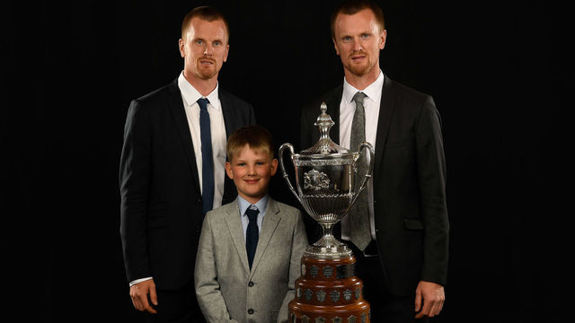 LAS VEGAS, NV - JUNE 20: Daniel Sedin (L) and Henrik Sedin, formerly of the Vancouver Canucks, and Henrik's son Harry pose for a portrait with the King Clancy Memorial Trophy at the 2018 NHL Awards at the Hard Rock Hotel & Casino on June 20, 2018 in Las Vegas, Nevada.