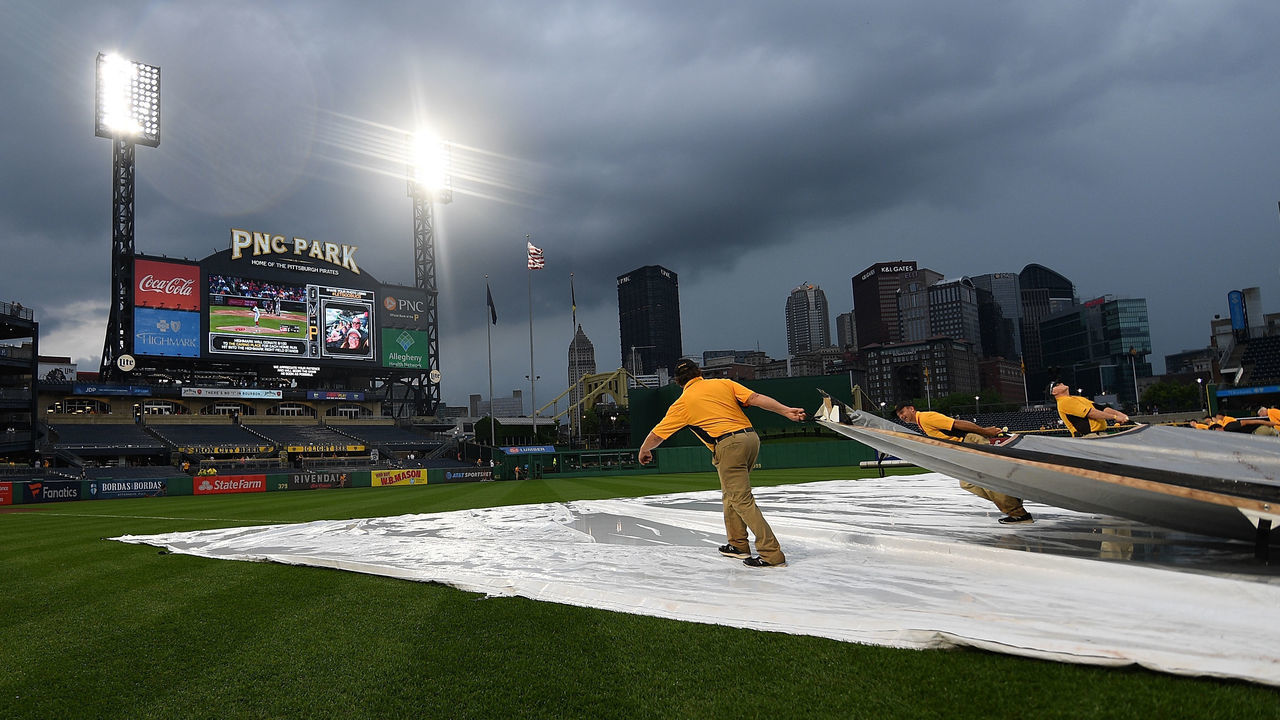 PITTSBURGH, PA - JUNE 20: The PNC Park grounds crew removes the tarp from the field during a rain delay in the game between the Pittsburgh Pirates and the Milwaukee Brewers at PNC Park on June 20, 2018 in Pittsburgh, Pennsylvania.