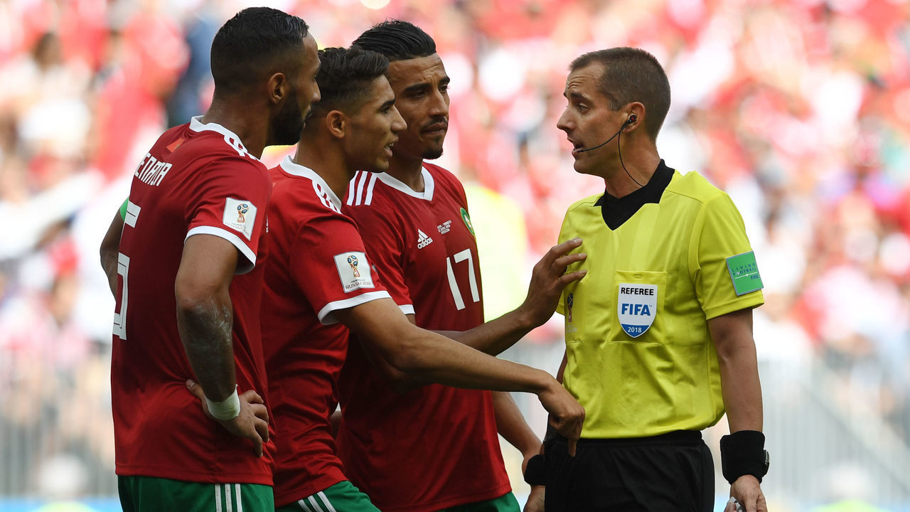 American referee Mark Geiger (R) speaks with Morocco's players during the Russia 2018 World Cup Group B football match between Portugal and Morocco at the Luzhniki Stadium in Moscow on June 20, 2018.