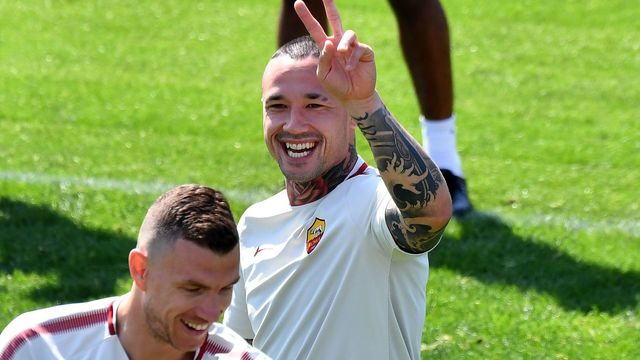 As Roma's players midfielder Radja Nainggolan (R) and striker Edin Dzeko joke as they takes part in a training session, on the eve of the Champions League semi-final, first-leg football match Liverpool vs AS Roma on April 23, 2018 at Trigoria training ground in the outskirts of Rome.