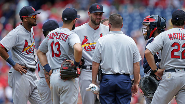 PHILADELPHIA, PA - JUNE 20: starting pitcher Michael Wacha #52 of the St. Louis Cardinals speaks with the Cardinals team trainer before being removed from the game due to injury in the fourth inning during a game against the Philadelphia Phillies at Citizens Bank Park on June 20, 2018 in Philadelphia, Pennsylvania. The Phillies won 4-3.