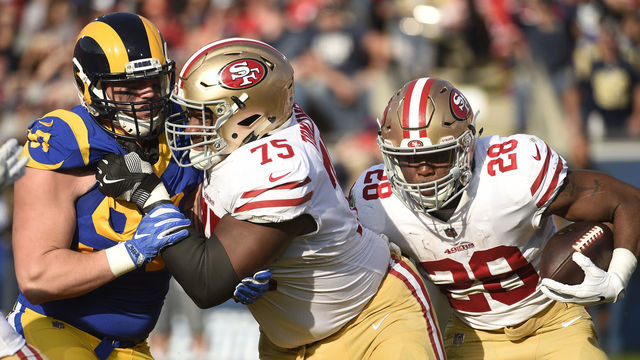 LOS ANGELES, CA - DECEMBER 31: Carlos Hyde #28 of the San Francisco 49ers follows his blocker Laken Tomlinson #75 of the San Francisco 49ers as he rushes for a gain against Los Angeles Rams during the second quarter at Los Angeles Memorial Coliseum on December 31, 2017 in Los Angeles, California.