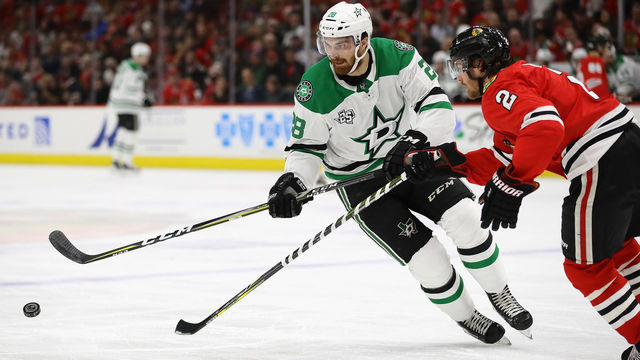 CHICAGO, IL - FEBRUARY 08: Stephen Johns #28 of the Dallas Stars advances the puck against Duncan Keith #2 of the Chicago Blackhawks chase the puck at the United Center on February 8 2018 in Chicago, Illinois.