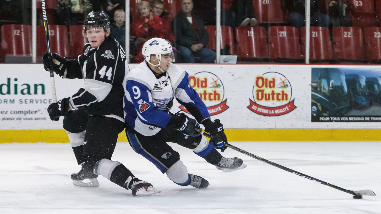 GATINEAU, CANADA - DECEMBER 1: Joe Veleno #9 of the Saint John Sea Dogs falls onto the ice as he controls the puck against Gabriel Bilodeau #44 of the Gatineau Olympiques on December 1, 2017 at Robert Guertin Arena in Gatineau, Quebec, Canada.