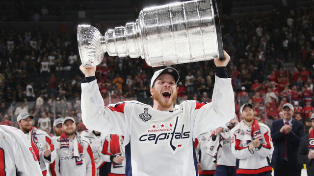 LAS VEGAS, NV - JUNE 07: John Carlson #74 of the Washington Capitals carries the Stanley Cup in celebration after his team defeated the Vegas Golden Knights 4-3 in Game Five of the 2018 NHL Stanley Cup Final at the T-Mobile Arena on June 7, 2018 in Las Vegas, Nevada.