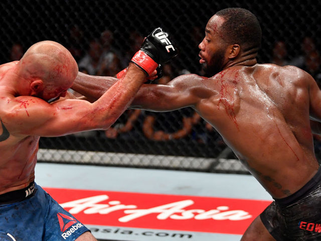 SINGAPORE - JUNE 23: (R-L) Leon Edwards of Jamaica punches Donald Cerrone in their welterweight bout during the UFC Fight Night event at the Singapore Indoor Stadium on June 23, 2018 in Singapore.