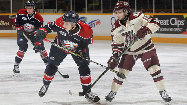 PETERBOROUGH, ON - OCTOBER 26: Blade Jenkins #19 of the Saginaw Spirit skates against Adam Timleck #18 of the Peterborough Petes in an OHL game at the Peterborough Memorial Centre on October 26, 2017 in Peterborough, Ontario, Canada.