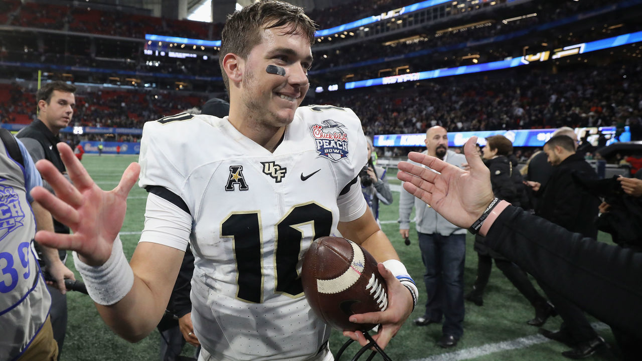 ATLANTA, GA - JANUARY 01: McKenzie Milton #10 of the UCF Knights reacts after defeating the Auburn Tigers 34-27 to win the Chick-fil-A Peach Bowl at Mercedes-Benz Stadium on January 1, 2018 in Atlanta, Georgia.