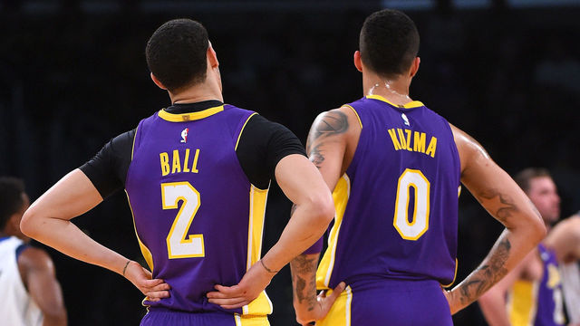 LOS ANGELES, CA - MARCH 28: Kyle Kuzma #0 and Lonzo Ball #2 of the Los Angeles Lakers wait on the court during a time out in the game against the Dallas Mavericks at Staples Center on March 28, 2018 in Los Angeles, California.