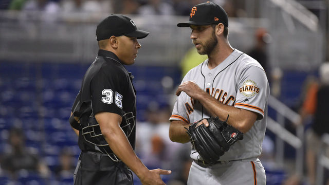 MIAMI, FL - JUNE 11: Madison Bumgarner #40 of the San Francisco Giants talks to Home Plate Umpire Jeremie Rehak in between innings of the game against the Miami Marlins at Marlins Park on June 11, 2018 in Miami, Florida.