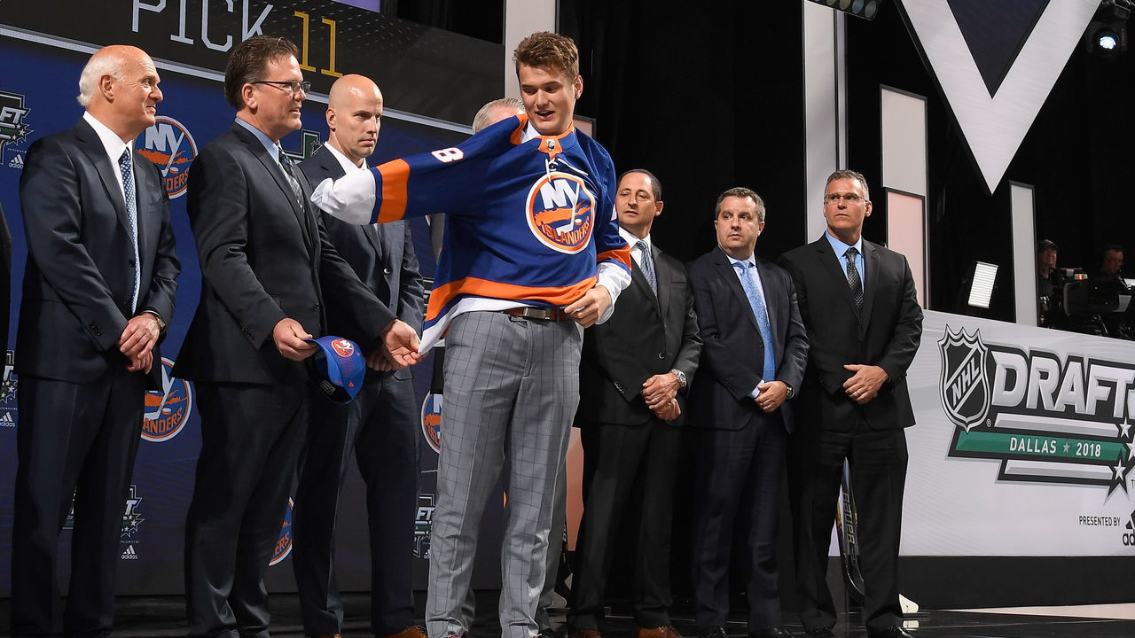 DALLAS, TX - JUNE 22: Oliver Wahlstrom puts on a New York Islanders jersey after being selected eleventh overall by the New York Islanders during the first round of the 2018 NHL Draft at American Airlines Center on June 22, 2018 in Dallas, Texas.