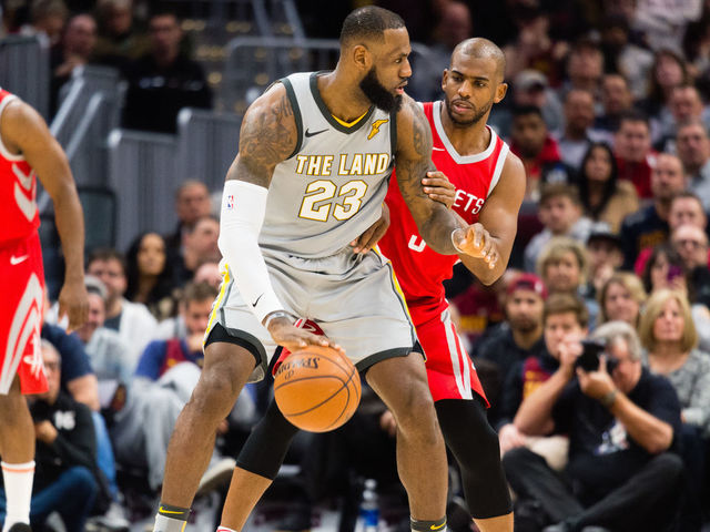CLEVELAND, OH - FEBRUARY 3: LeBron James #23 of the Cleveland Cavaliers tries to drive around Chris Paul #3 of the Houston Rockets during the first half at Quicken Loans Arena on February 3, 2018 in Cleveland, Ohio.