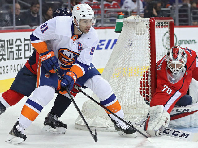WASHINGTON, DC - MARCH 16: John Tavares #91 of the New York Islanders skates in front og goalie Braden Holtby #70 of the Washington Capitals during the first period at Capital One Arena on March 16, 2018 in Washington, DC.