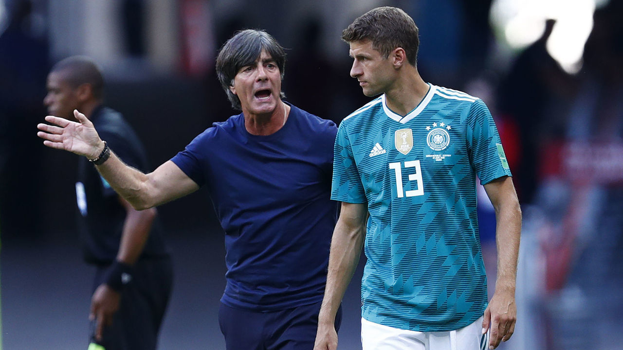 Germany's coach Joachim Loew speaks with Germany's forward Thomas Mueller (R) ahead of being substituted during the Russia 2018 World Cup Group F football match between South Korea and Germany at the Kazan Arena in Kazan on June 27, 2018.