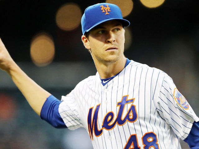 NEW YORK, NY - MAY 02: Jacob deGrom #48 of the New York Mets walks back to the dugout after he made the out at first to end the second inning against the Atlanta Braves on May 2, 2018 at Citi Field in the Flushing neighborhood of the Queens borough of New York City.