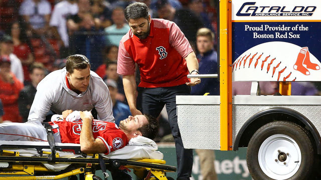 BOSTON, MA - JUNE 27: Jake Jewell #65 of the Los Angeles Angels is carted off the field after he injured his right ankle when he slid into home plate in a failed attempt to tag out J.D. Martinez #28 of the Boston Red Sox in the eighth inning of a game at Fenway Park on June 27, 2018 in Boston, Massachusetts.