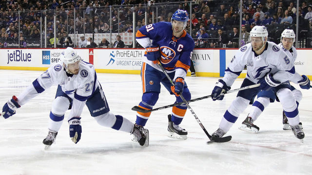 NEW YORK, NY - MARCH 22: Ryan McDonagh #27 and Dan Girardi #5 of the Tampa Bay Lightning defend against John Tavares #91 of the New York Islanders during the second period at the Barclays Center on March 22, 2018 in the Brooklyn borough of New York City.